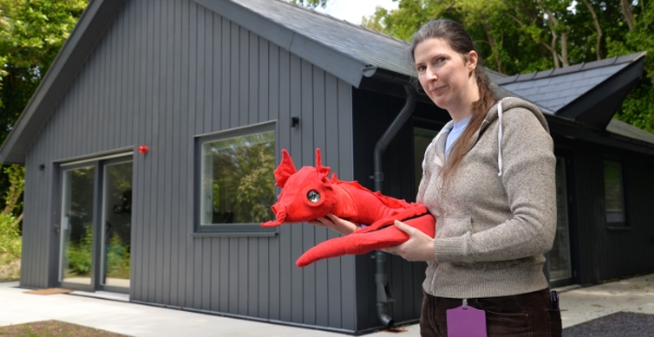 Dr Patricia Shaw with the Pet Dragon in front of the new Smart Home research lab