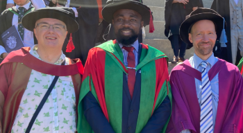 PhD Postgraduates with staff at graduation